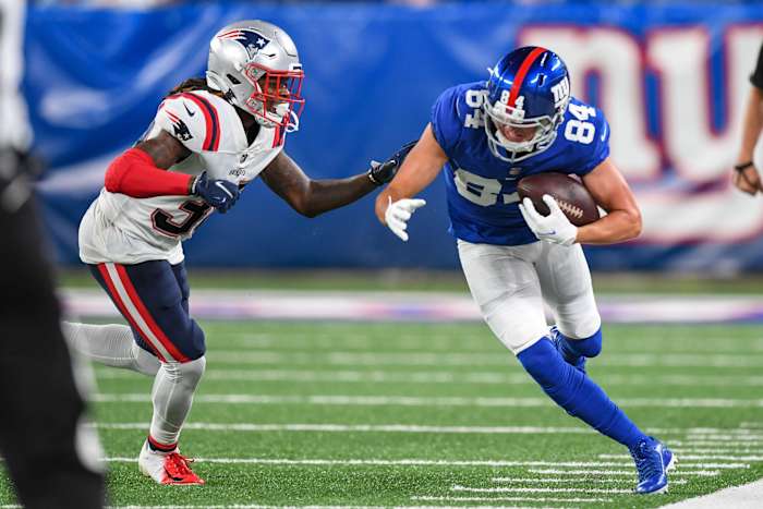 Aug 29, 2021; East Rutherford, New Jersey, USA; New York Giants wide receiver David Sills (84) catches pass and makes a run defended by New England Patriots defensive back Dee Virgin (38) during the third quarter at MetLife Stadium.